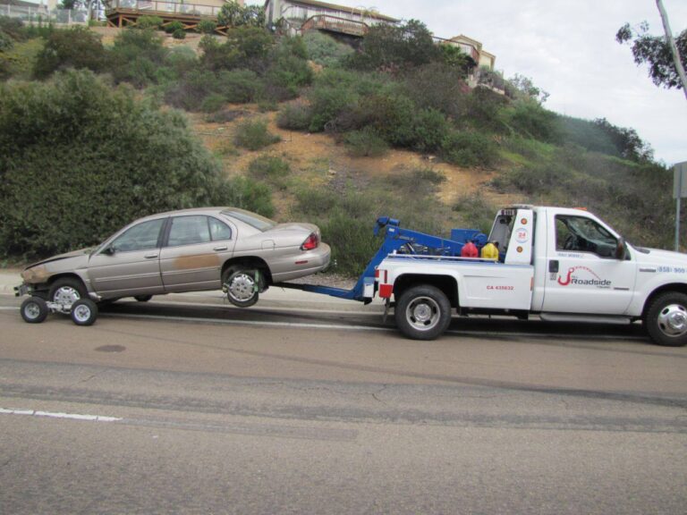 The wheel lift towing a car with dollies.  The professionals at All Roadside Towing, know how to get it done.