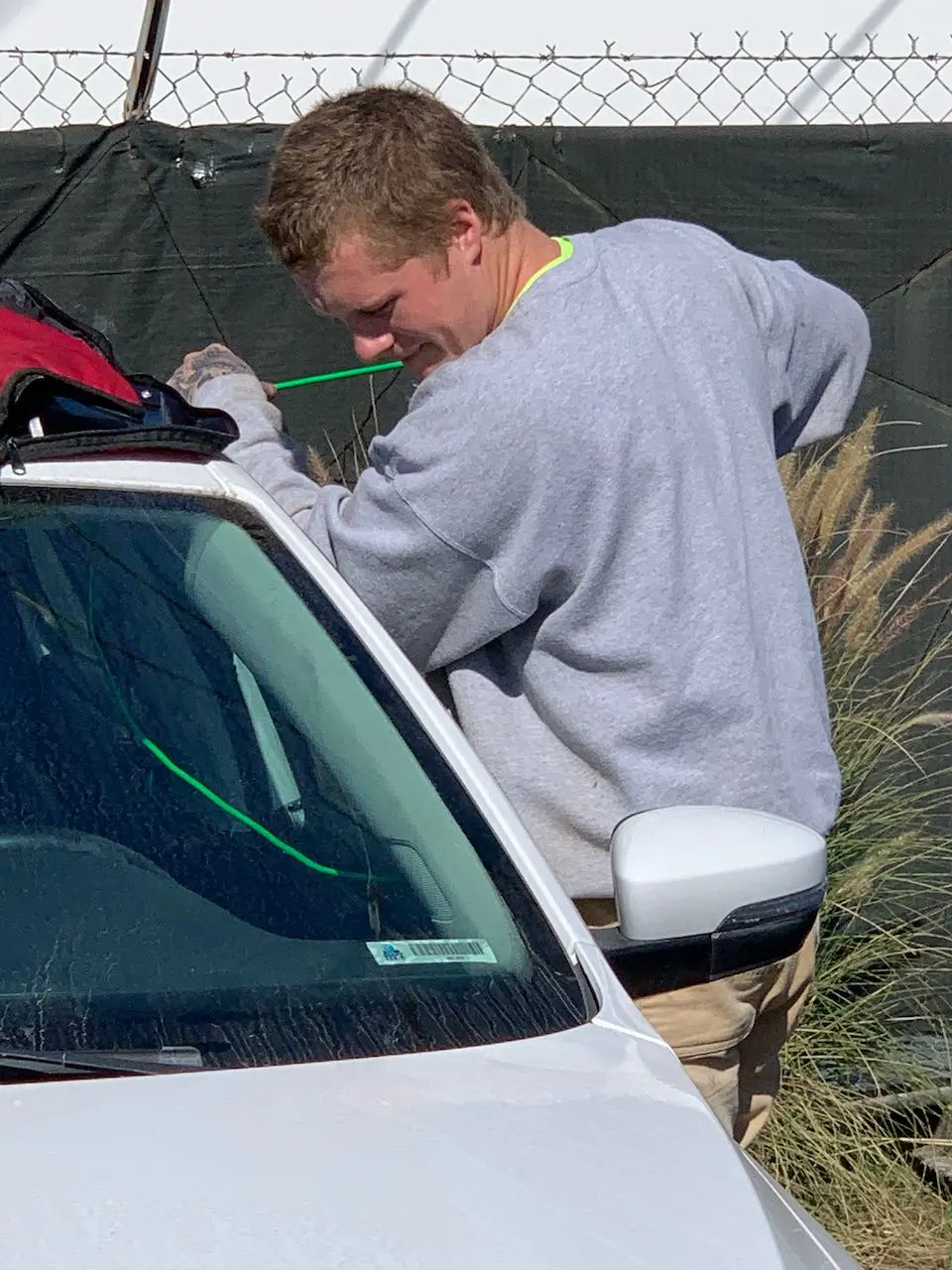 Unlocking a locked car. Brandon learning the ropes for Towing Company La Jolla.