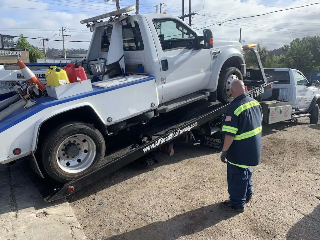 Loading the wheel lift tow truck onto a flatbed tow truck is no easy task. But All Roadside Towing can do it.