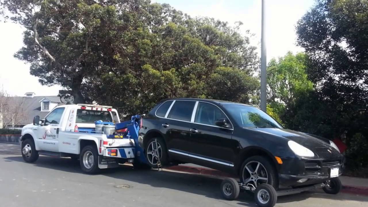 Tow Truck near me has deployed a  wrecker with dollies to tow this Porsche.