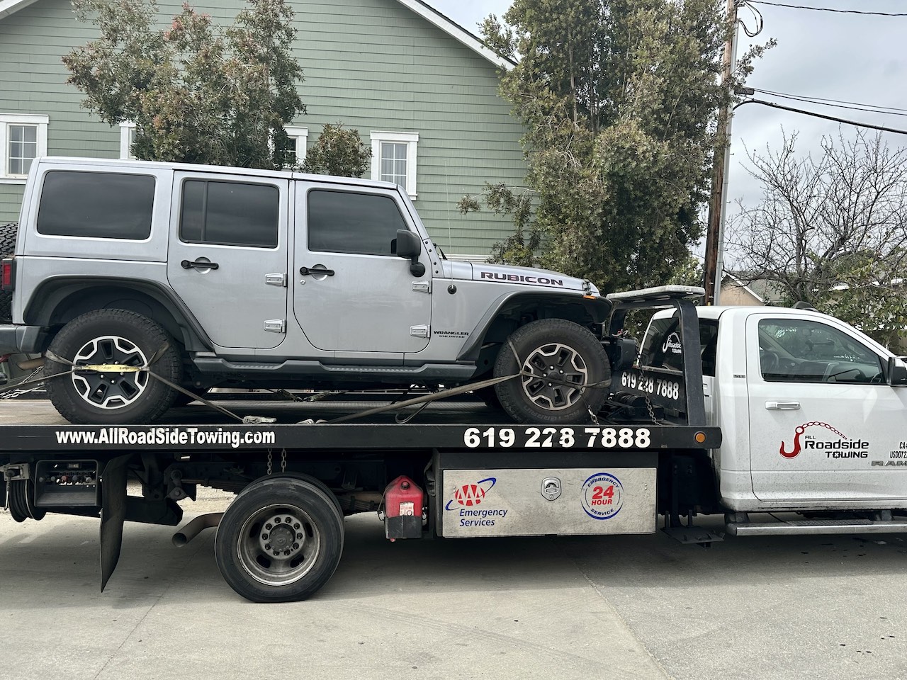 Jeep loaded on the back of Towing San Diego - the All Roadside Towing flatbed.